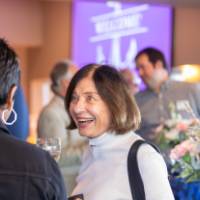 Woman actively listening to another reception attendee